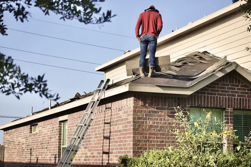 Professional roofer working on a residential roof in Eberton